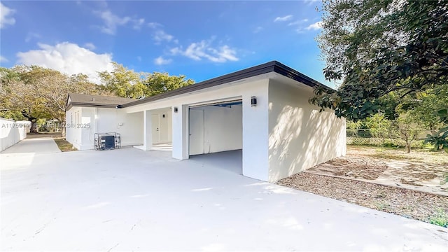 garage featuring fence and central AC