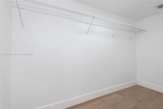 spacious closet with visible vents and light wood-style flooring