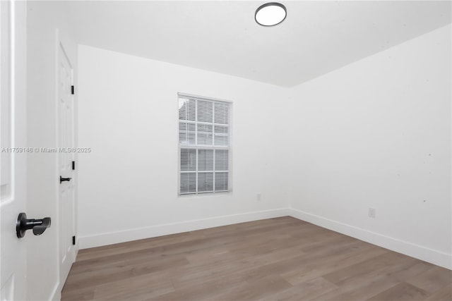 unfurnished room with light wood-style floors and baseboards