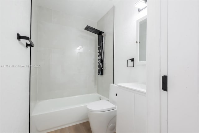 bathroom featuring bathtub / shower combination, toilet, wood finished floors, and vanity