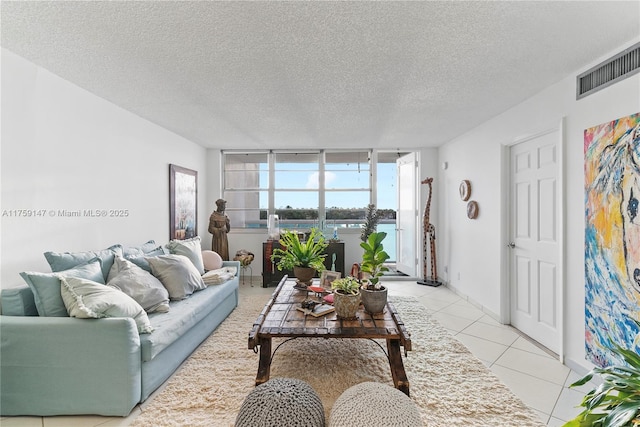 6770 Indian Creek Dr Unit 5K, Miami Beach, FL 33141 - living room with a water view, visible vents, a textured ceiling, and light tile patterned flooring