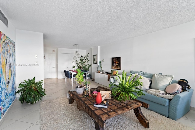 6770 Indian Creek Dr Unit 5K, Miami Beach, FL 33141 - living room featuring a textured ceiling and light tile patterned flooring