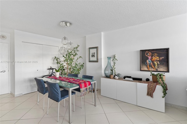 6770 Indian Creek Dr Unit 5K, Miami Beach, FL 33141 - dining area with light tile patterned floors and a textured ceiling