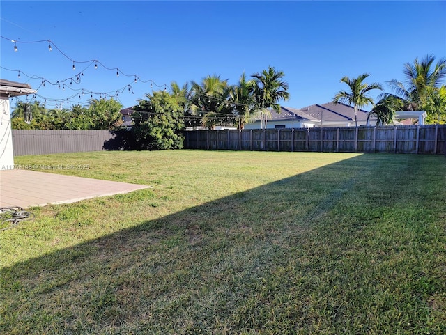 view of yard with a fenced backyard