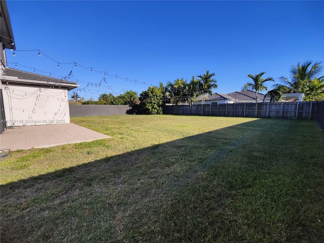 view of yard with a patio and a fenced backyard