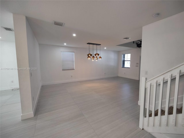 unfurnished room featuring visible vents, recessed lighting, and baseboards