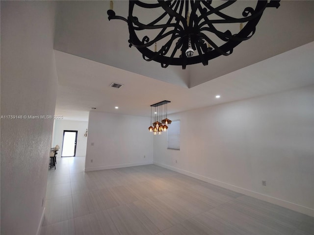 spare room with recessed lighting, visible vents, baseboards, and a notable chandelier