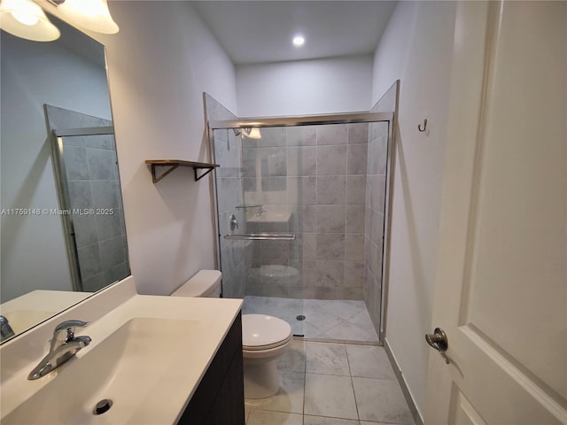 bathroom with vanity, toilet, and a stall shower