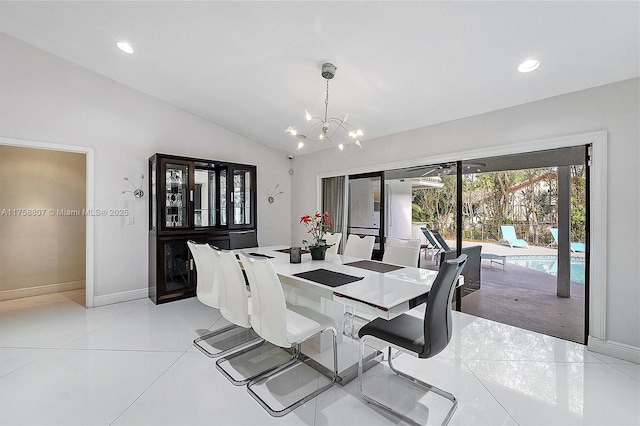 dining area featuring baseboards, vaulted ceiling, a notable chandelier, and light tile patterned flooring