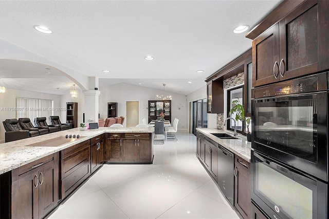 kitchen with dark brown cabinetry, black appliances, open floor plan, and lofted ceiling