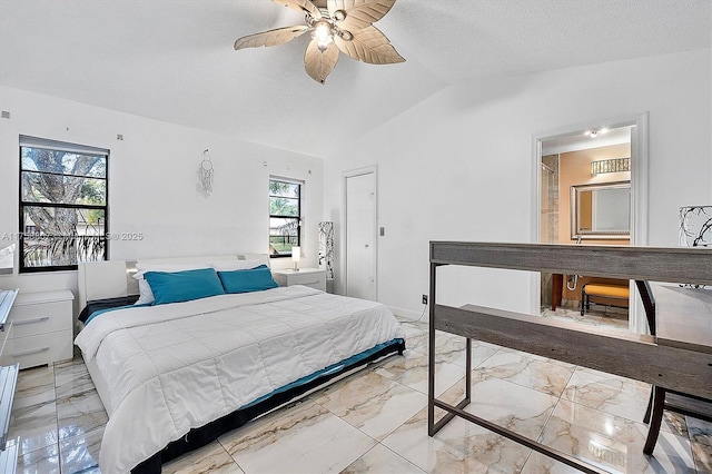 bedroom featuring marble finish floor, ceiling fan, vaulted ceiling, and a textured ceiling