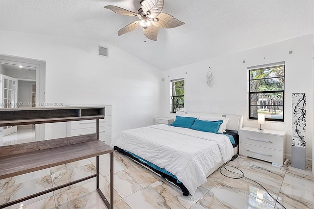 bedroom with visible vents, a ceiling fan, lofted ceiling, marble finish floor, and a textured ceiling