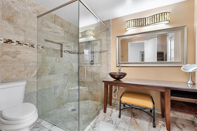 full bath with a stall shower, marble finish floor, a sink, and toilet