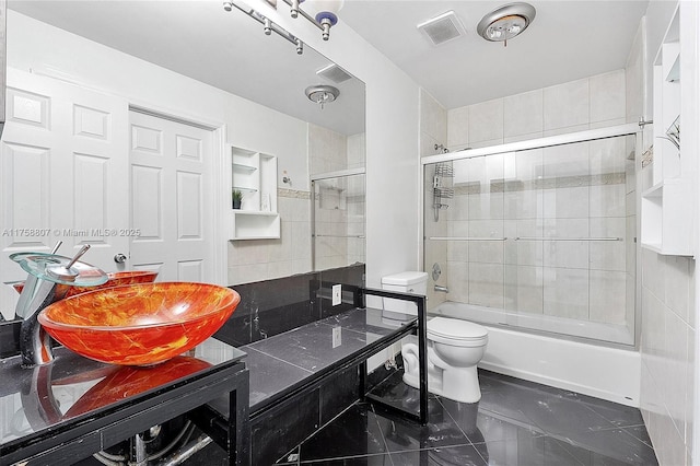 full bath featuring toilet, shower / bath combination with glass door, vanity, visible vents, and marble finish floor