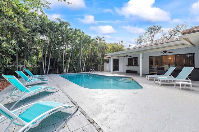 pool featuring a ceiling fan and a patio area