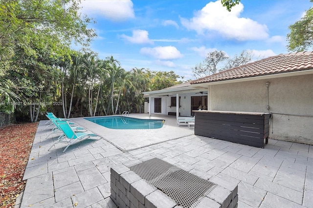 pool with a patio area and a ceiling fan