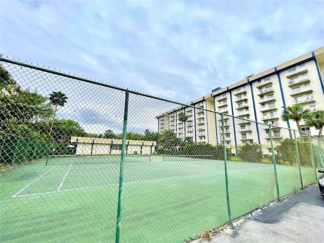 view of tennis court featuring fence