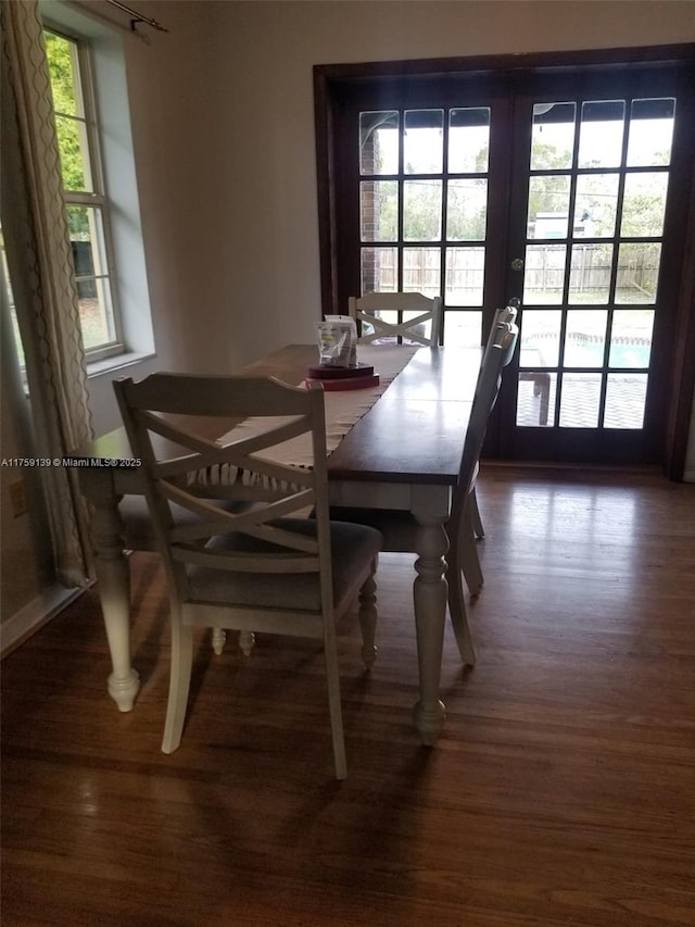 dining area with wood finished floors and french doors