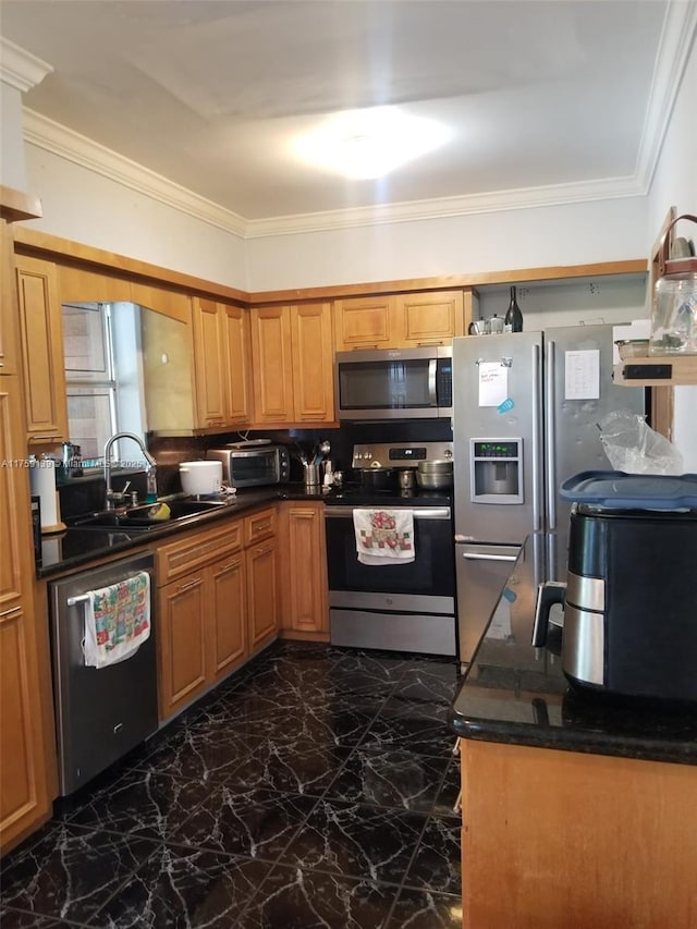 kitchen featuring a sink, marble finish floor, appliances with stainless steel finishes, dark countertops, and crown molding