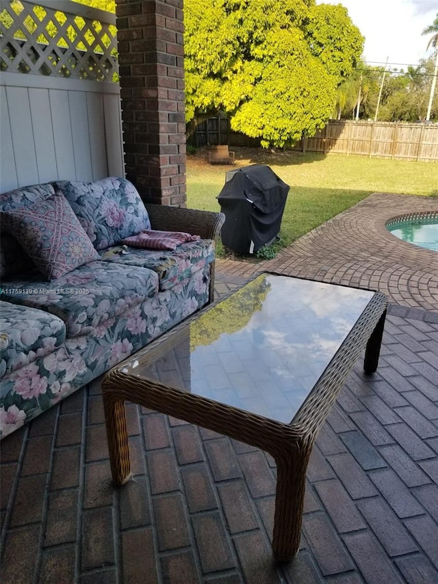 view of patio / terrace with a fenced backyard, outdoor lounge area, and area for grilling