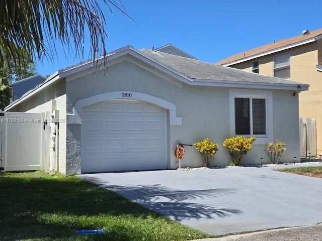 view of home's exterior with a garage, concrete driveway, roof with shingles, and stucco siding