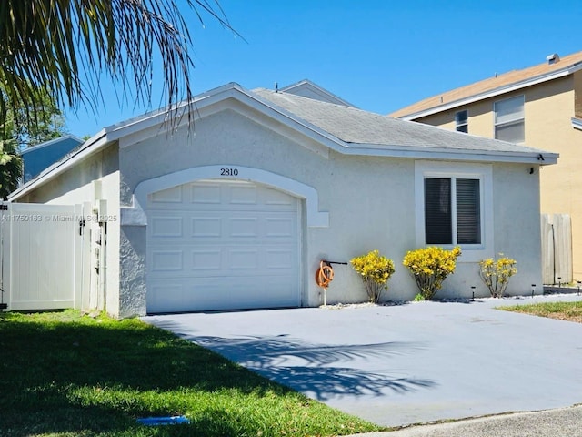single story home with concrete driveway, a garage, and stucco siding