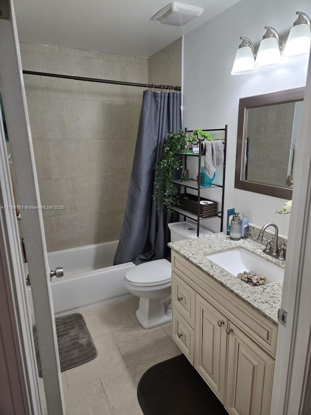 full bathroom featuring toilet, visible vents, vanity, tile patterned floors, and shower / bath combo with shower curtain