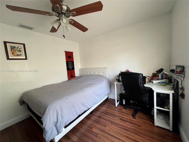 bedroom with baseboards, visible vents, ceiling fan, and wood finished floors