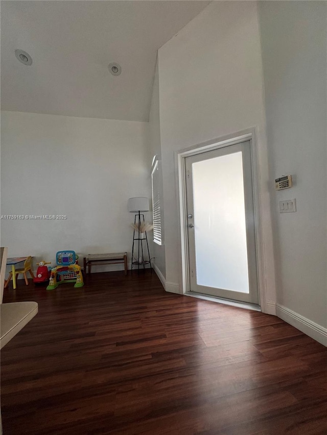 empty room featuring wood finished floors and baseboards