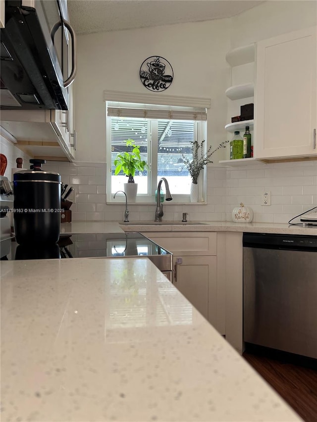 kitchen featuring open shelves, dishwasher, a sink, tasteful backsplash, and white cabinetry