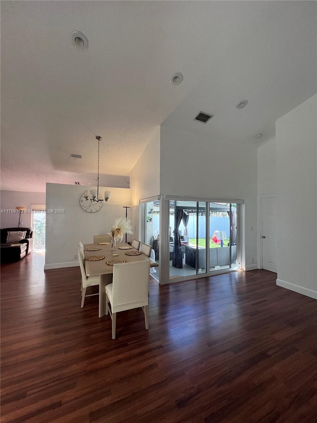 interior space featuring dark wood-style floors, a chandelier, visible vents, and baseboards