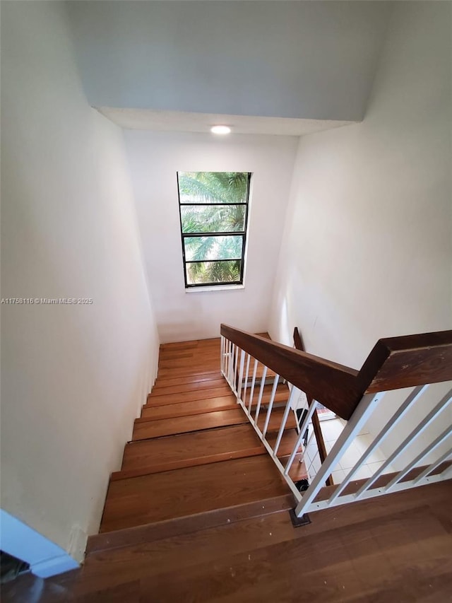 stairs featuring wood finished floors