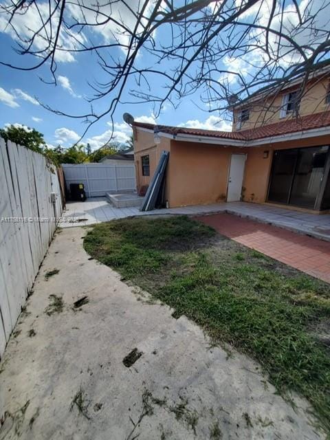 view of property exterior with a patio area, a fenced backyard, and stucco siding