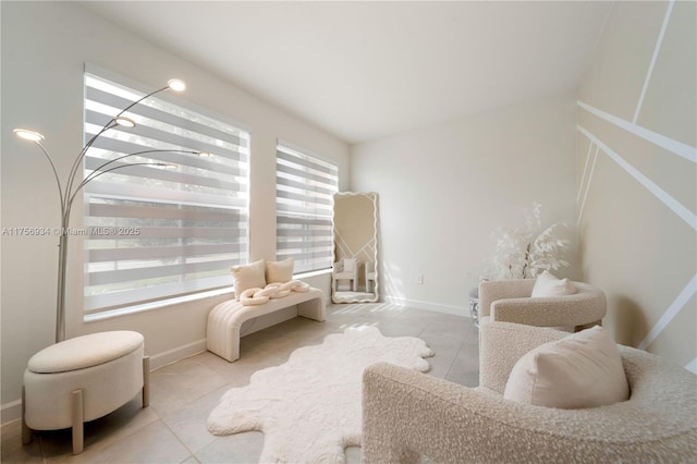 sitting room with baseboards and tile patterned floors