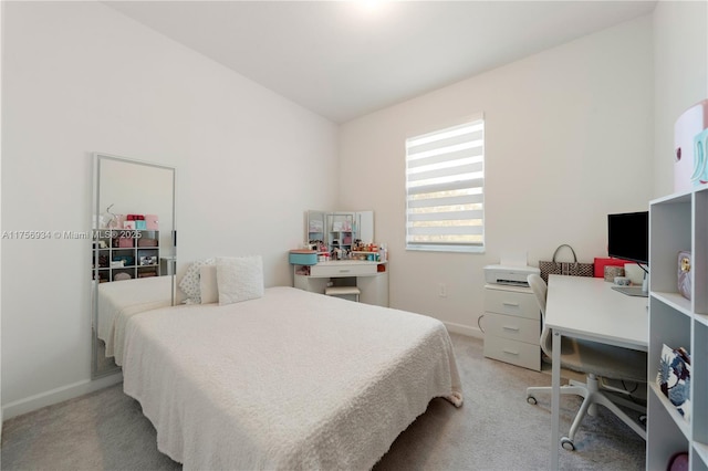 bedroom featuring light carpet and baseboards