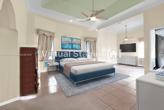 bedroom with a tray ceiling, tile patterned floors, and ornamental molding