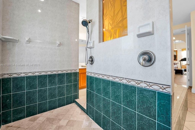 bathroom with ensuite bath, tile walls, tile patterned floors, and walk in shower