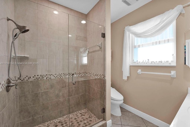 bathroom featuring tile patterned floors, visible vents, toilet, and a shower stall