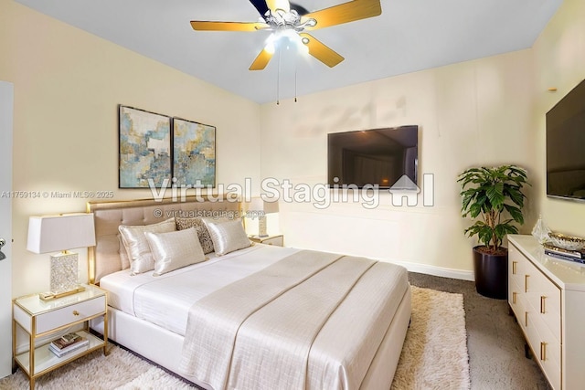 carpeted bedroom featuring baseboards and a ceiling fan