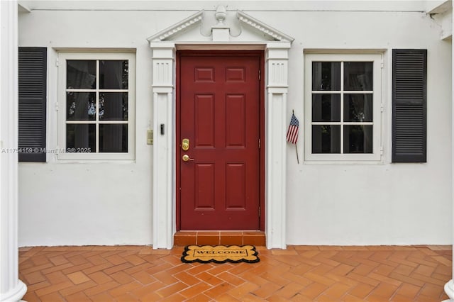 property entrance with stucco siding