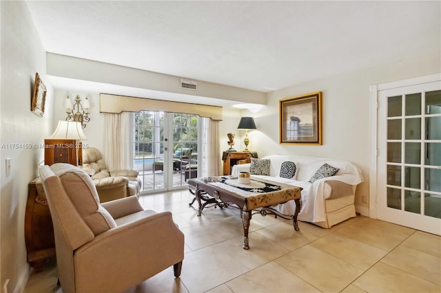 living room with light tile patterned floors, french doors, and visible vents