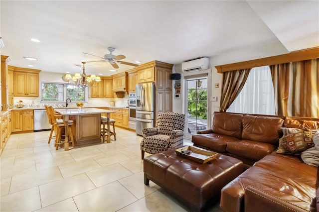 living room featuring ceiling fan with notable chandelier, light tile patterned flooring, an AC wall unit, and recessed lighting