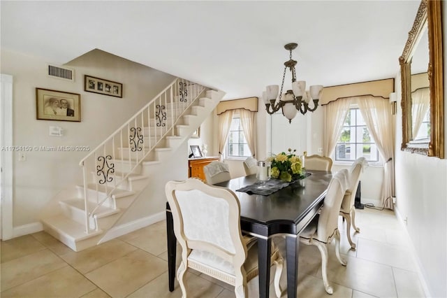 dining area with a wealth of natural light, visible vents, a notable chandelier, and stairway