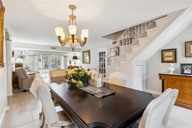 dining space featuring light tile patterned floors, a chandelier, visible vents, stairs, and french doors