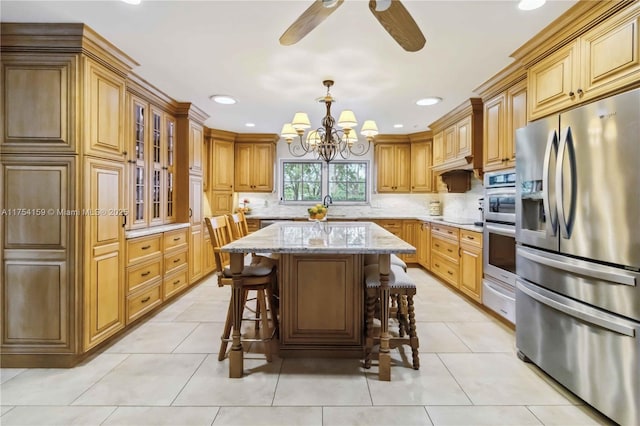 kitchen with stainless steel refrigerator with ice dispenser, light tile patterned floors, a sink, light stone countertops, and a kitchen bar