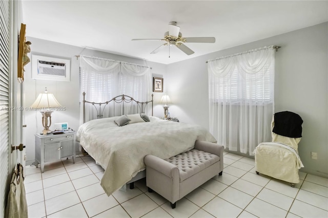 bedroom featuring a wall unit AC, ceiling fan, and light tile patterned flooring