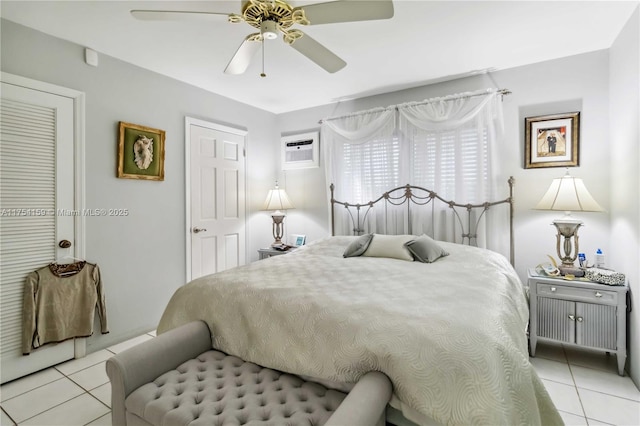 bedroom with a ceiling fan, an AC wall unit, and light tile patterned flooring