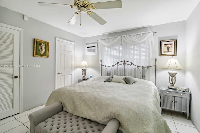 bedroom with light tile patterned floors, a ceiling fan, and a wall mounted air conditioner