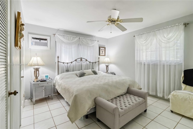 bedroom with light tile patterned floors, ceiling fan, and a wall mounted AC