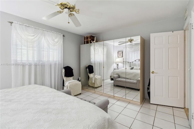 bedroom featuring light tile patterned floors and ceiling fan